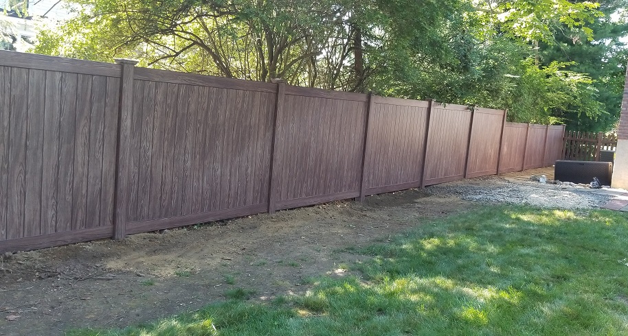 Walnut wood grain vinyl maintenance free fence