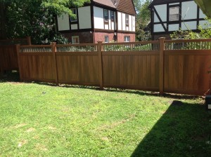 Vinyl wood grain fence with bronze aluminum spindle top combination maintenance free fence Bronxville NY